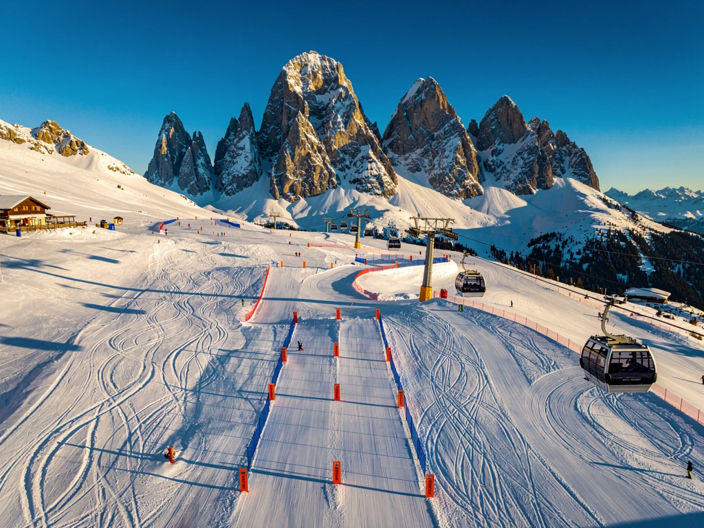 Luchtfoto van skigebied Scheffau am Wilden Kaiser met besneeuwde pistes, gondelbaan en Oostenrijkse Alpen op achtergrond
