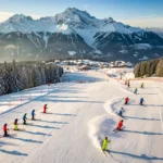 Ski instructors teaching groups on groomed alpine slopes in Schröcken, Austria during golden hour with snow-capped peaks.